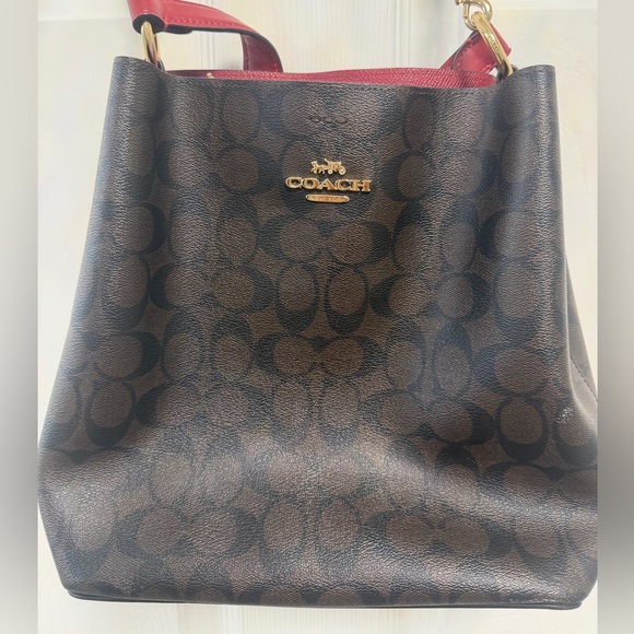 Coach Handbags - COACH Brown Signature Bucket Bag with Red Trim